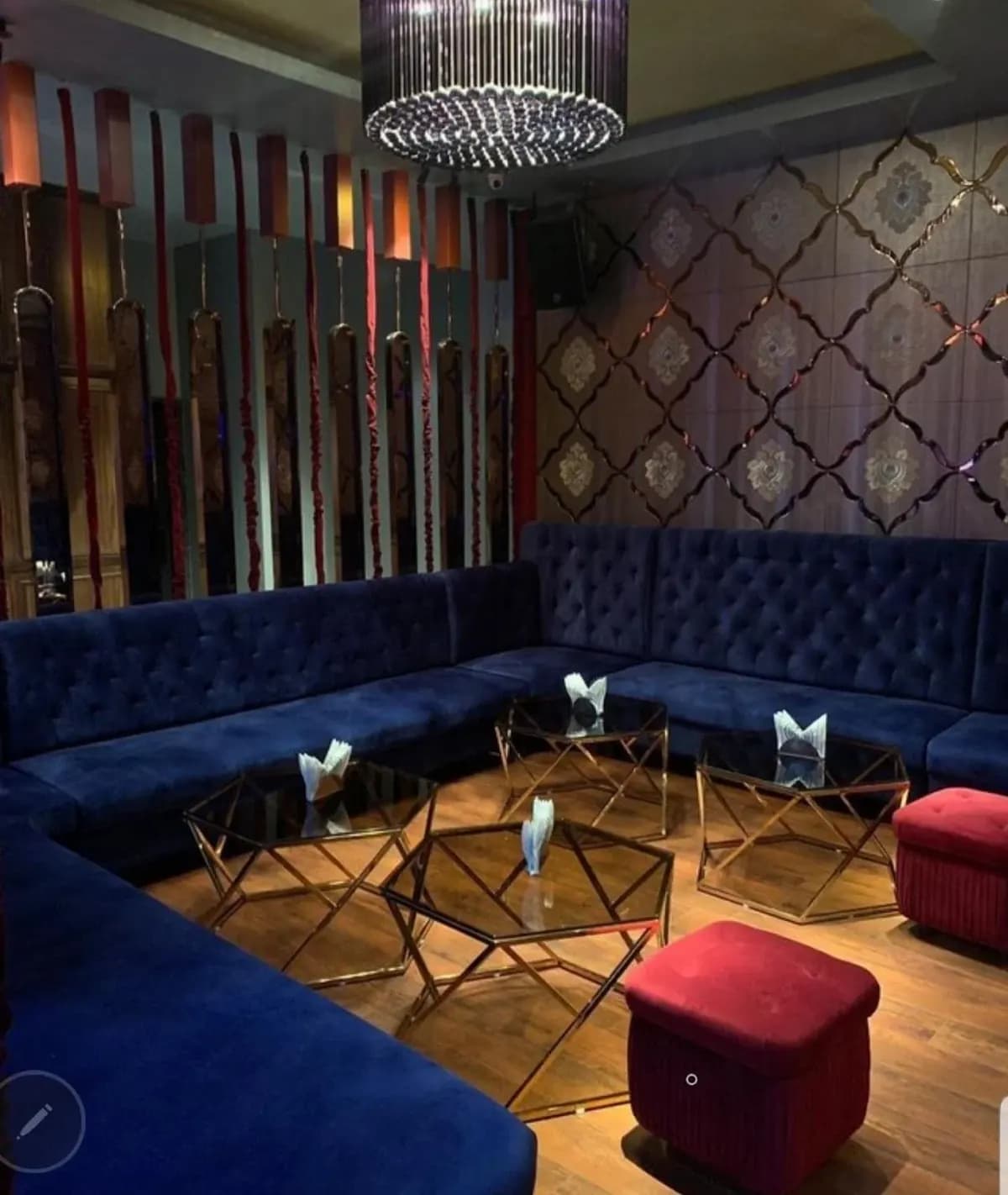 Lounge bar interior with blue velvet seating and patterned walls